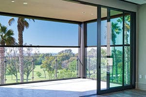 A large open window with a view of the golf course.